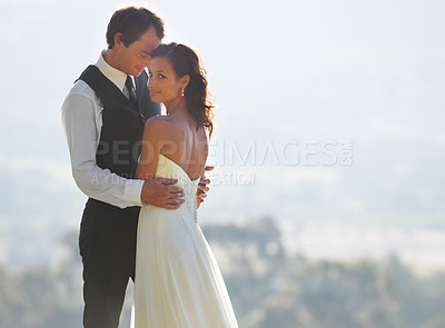 Buy stock photo Couple hug, bride and groom at wedding, outdoor in nature for social event with love and commitment. Man, woman and marriage, celebrate with trust and care together on hill with life partner