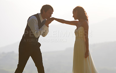 Buy stock photo Couple, park or kiss on hand in wedding for outdoor celebration, care or ceremony event. Marriage, romantic groom or proud bride in bridal garment for commitment, love or fashion in summer or garden