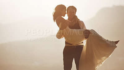 Buy stock photo A groom carrying his bride