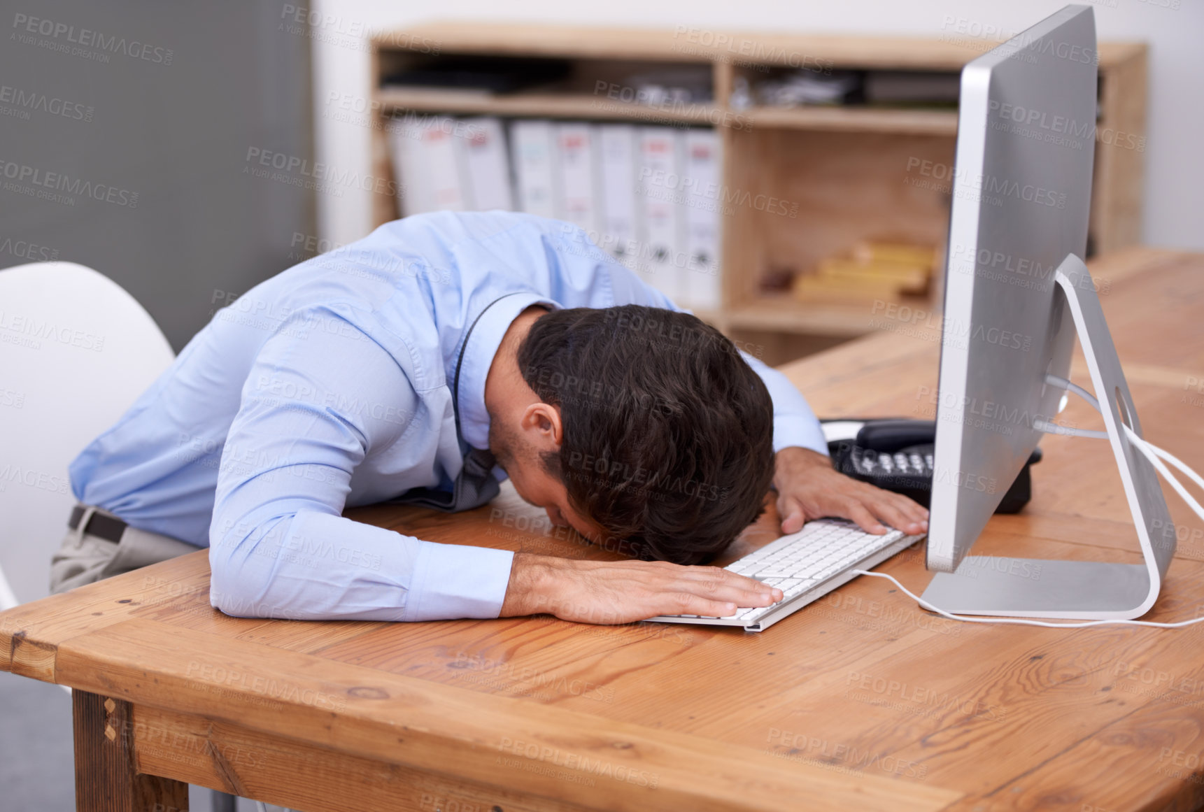 Buy stock photo Cropped shot of a businessman banging his head on the desk