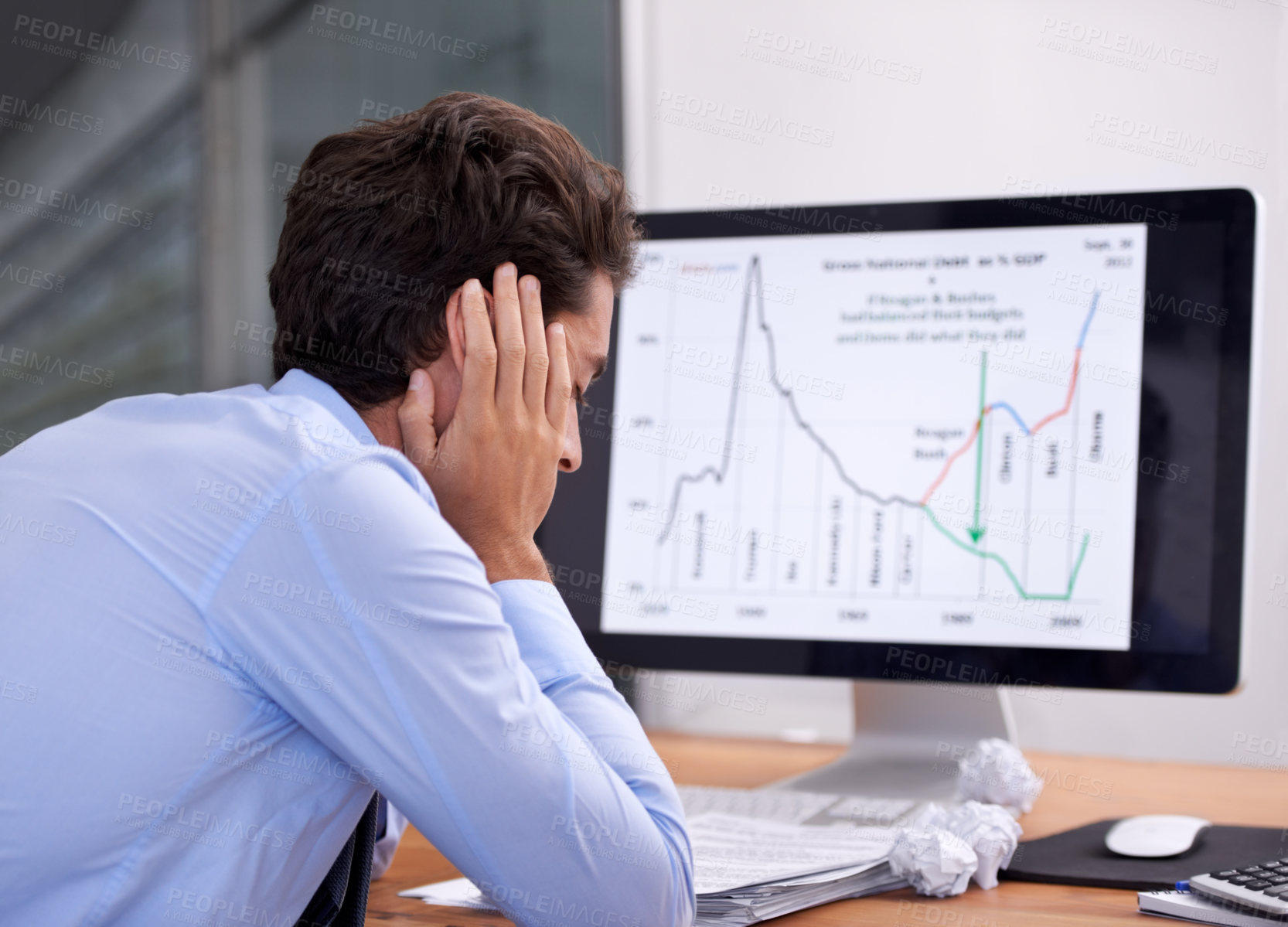 Buy stock photo Rearview shot of a frustrated-looking businessman sitting at his desk