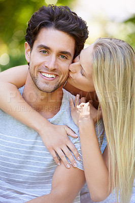 Buy stock photo Couple, hug and woman kiss man in park with smile, love and commitment in healthy relationship. People on date outdoor, portrait and care with trust, partner and bonding together for marriage 