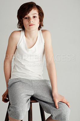 Buy stock photo Portrait of a young boy sitting on a stool in the studio