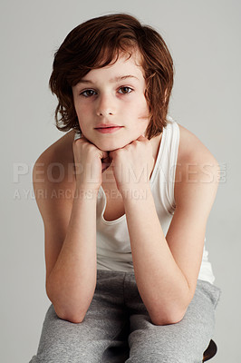 Buy stock photo Portrait, fashion and boy child in a studio with cool, casual and stylish outfit with positive attitude. Youth, confident and young kid model on stool with style isolated by gray background.