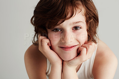 Buy stock photo Portrait of a young boy resting his head in his hands