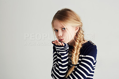 Buy stock photo Fashion, kiss and portrait of child in a studio with casual, cool and stylish outfit and hat. Happy, youth and young girl kid with positive, good and confident attitude for style by white background