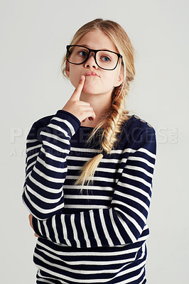 Buy stock photo Thinking, focus and girl with ideas, future and fantasy against a grey studio background. Female child, smart kid and young person with thoughts, wonder and fantasy with concentration and daydreaming