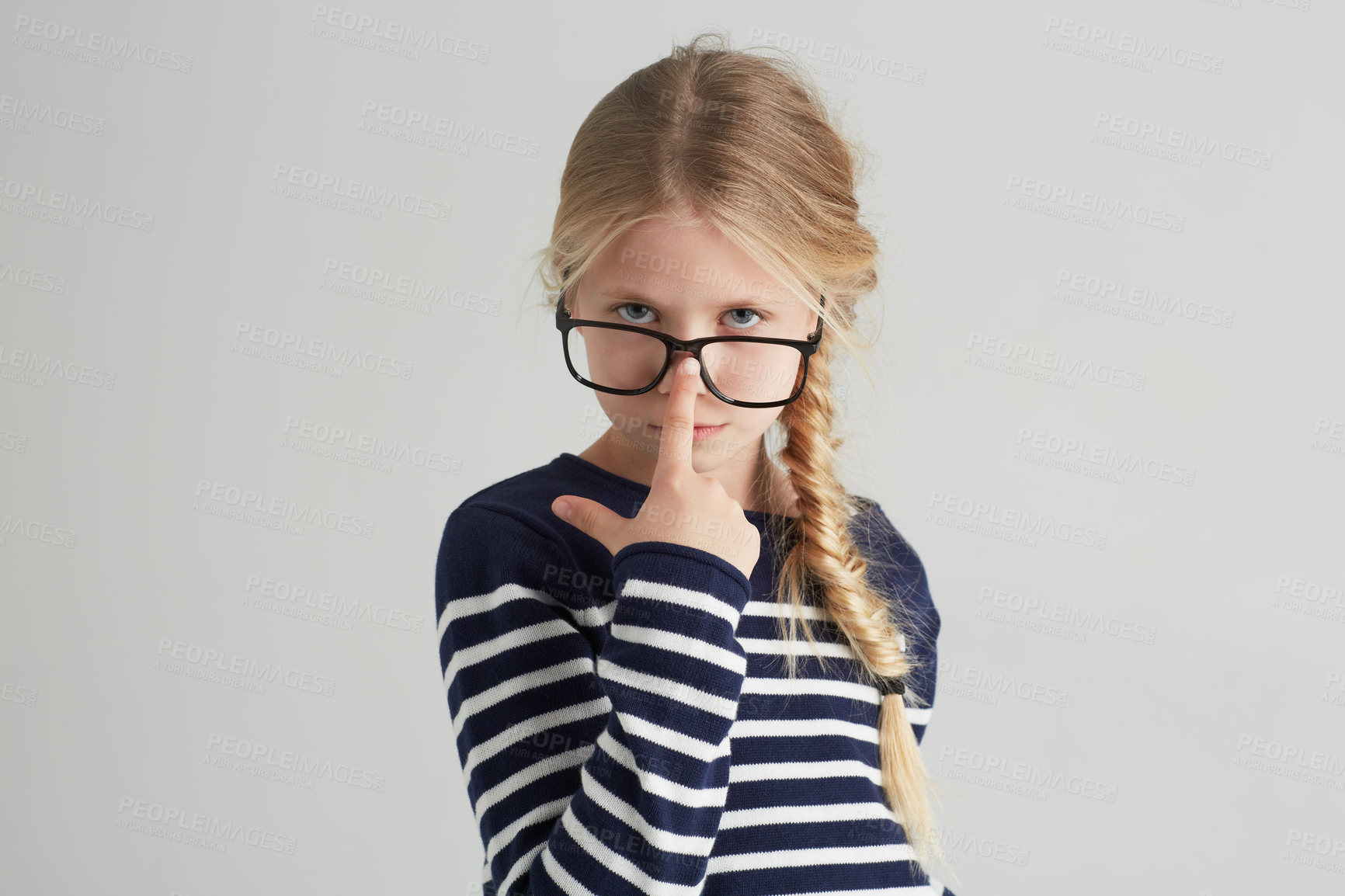 Buy stock photo Child, portrait and glasses with serious in mockup, thought and eyewear or nose in studio. Girl, face or geek with blonde hair in fashion with vision, contemplation or smart kid by white background