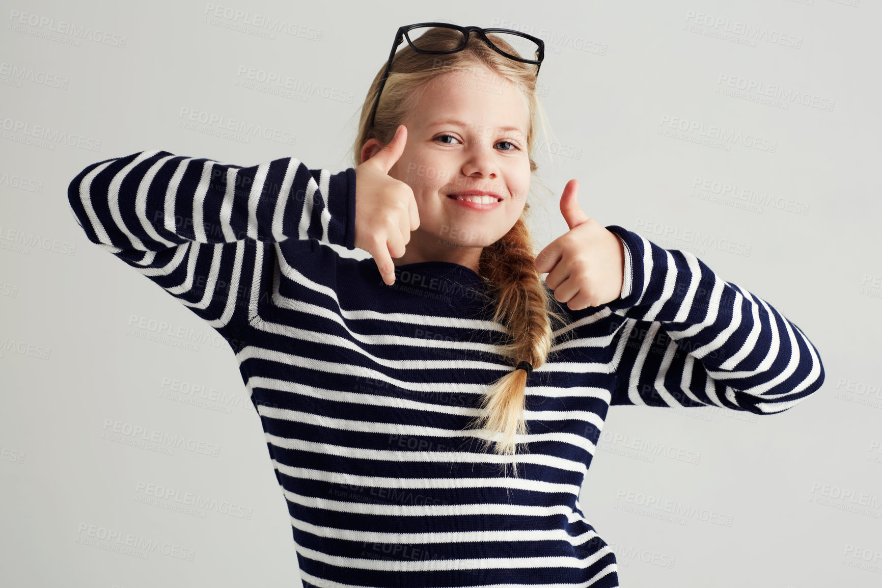 Buy stock photo Thank you, thumbs up and portrait of young girl or child doing yes, celebrate or happy sign with hand. Glasses, agree and female kid or person smile and like gesture in a grey studio background