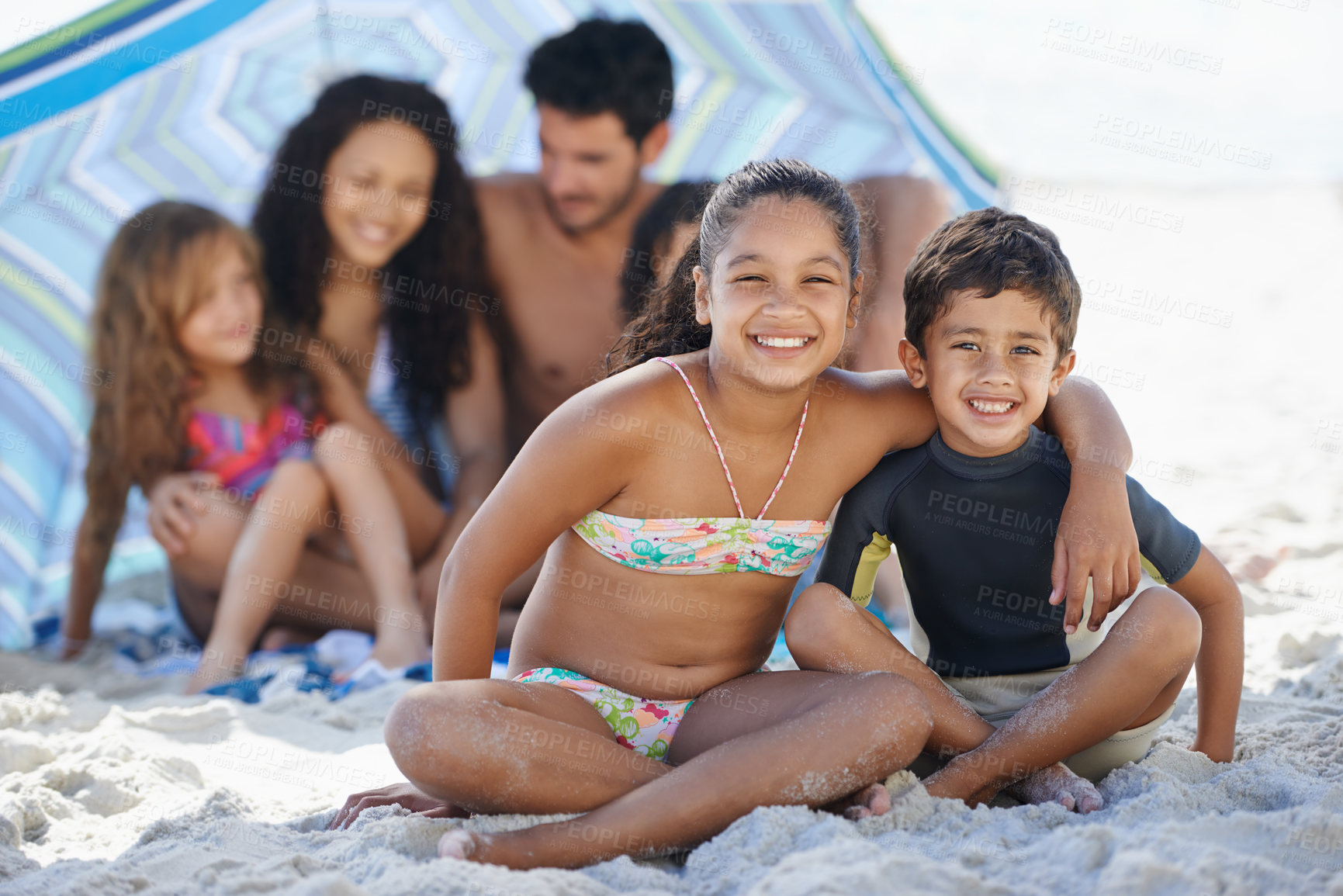Buy stock photo Girl, boy with family on beach and smile in portrait, summer vacation with hug, bonding and love. People outdoor, holiday in Brazil with sand and sun, children happy for travel and adventure together