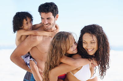 Buy stock photo Happy family, beach and piggyback for bonding, vacation or outdoor holiday weekend together. Father, mother and children smile for hug, love or back ride on summer break by the ocean coast in nature