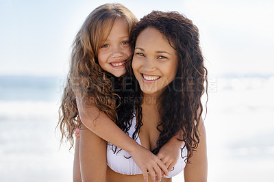 Buy stock photo Happy mother, portrait and child hug at beach for summer holiday, bonding or outdoor love together. Face of mom and little girl, kid or daughter smile for embrace, support or piggyback at ocean coast