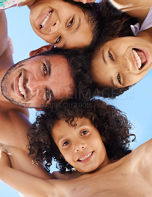 Buy stock photo A family of four in swimwear smiling against a bright sky