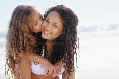 Buy stock photo A young mother and her daughter on the beach