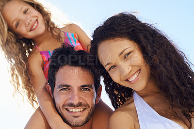 Buy stock photo Happy family, portrait and bonding on beach vacation or outdoor holiday weekend together. Face of father, mother and child smile for piggyback, love or summer break by the ocean coast in nature
