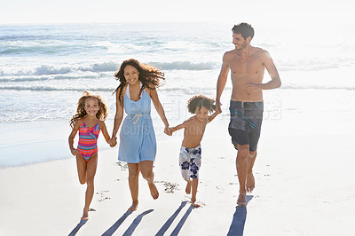 Buy stock photo Happy family, water and holding hands on beach for bonding, summer fun or outdoor holiday together. Mother, father and children smile while walking by waves on ocean coast, sand or shore in nature