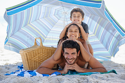 Buy stock photo Father, kids and smile in portrait on beach, summer vacation with parasol, bonding and love. People outdoor, holiday in Brazil with sand and sun, smile for travel and adventure together in nature