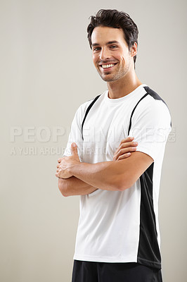 Buy stock photo Portrait of a handsome young man standing with his arms crossed