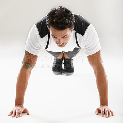 Buy stock photo Fitness, push ups or sports man training in studio for muscle or strong arms on floor in exercise. Power, white background or healthy athlete in calisthenics for wellness, energy or body workout
