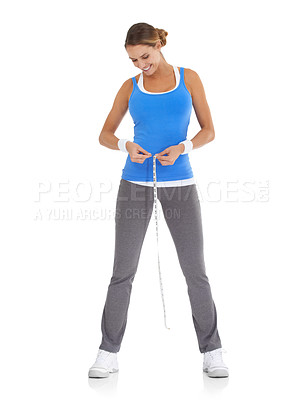 Buy stock photo Young woman in sportswear measuring her waistline while isolated on white
