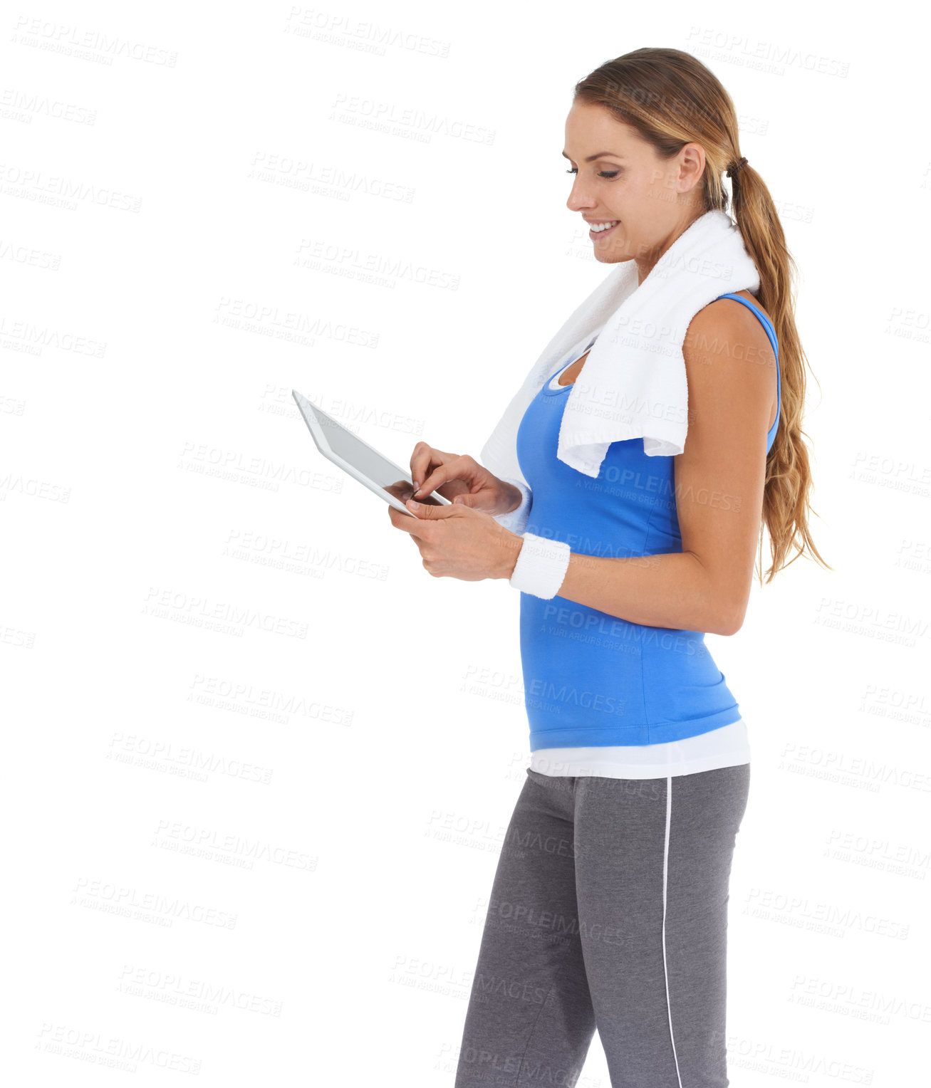 Buy stock photo Young woman in sportswear using a tablet while isolated on white