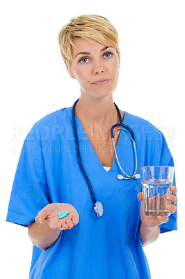 Buy stock photo A young female doctor holding pills and a glass of water