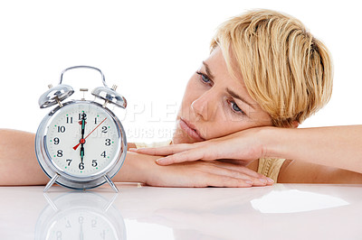 Buy stock photo Sad woman, alarm clock and alert for wakeup or deadline on a white studio background. Upset or disappointed female person or blonde looking at time in failure, loss or bored on table on mockup space