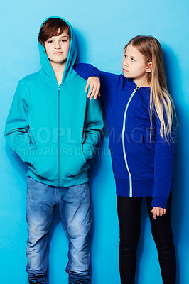 Buy stock photo Fashion, portrait and teenager models in a studio with a casual, cool and stylish outfit. Youth, friendship and young boy and girl posing together with trendy apparel style by a blue background.