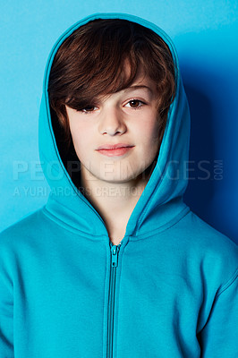 Buy stock photo Portrait of a young boy wearing a blue hoodie in the studio