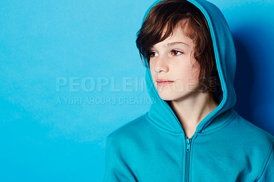 Buy stock photo Studio, fashion and young child in hoodie, trendy apparel or stylish outfit isolated on blue background. Mockup space, fashionable style and youth kid with winter clothes, casual outfit and thinking 