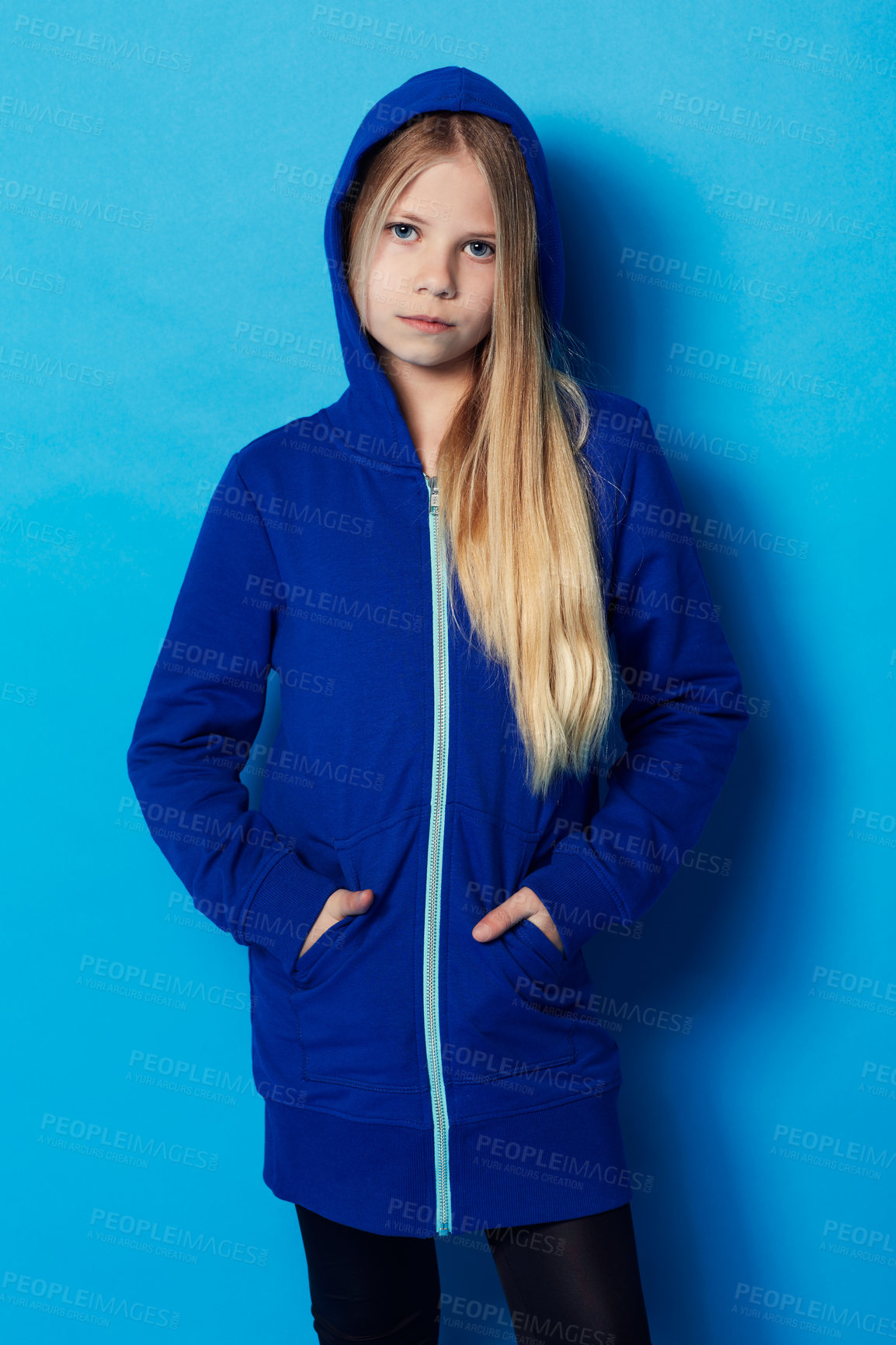 Buy stock photo Portrait of a young girl wearing a blue hoodie in the studio