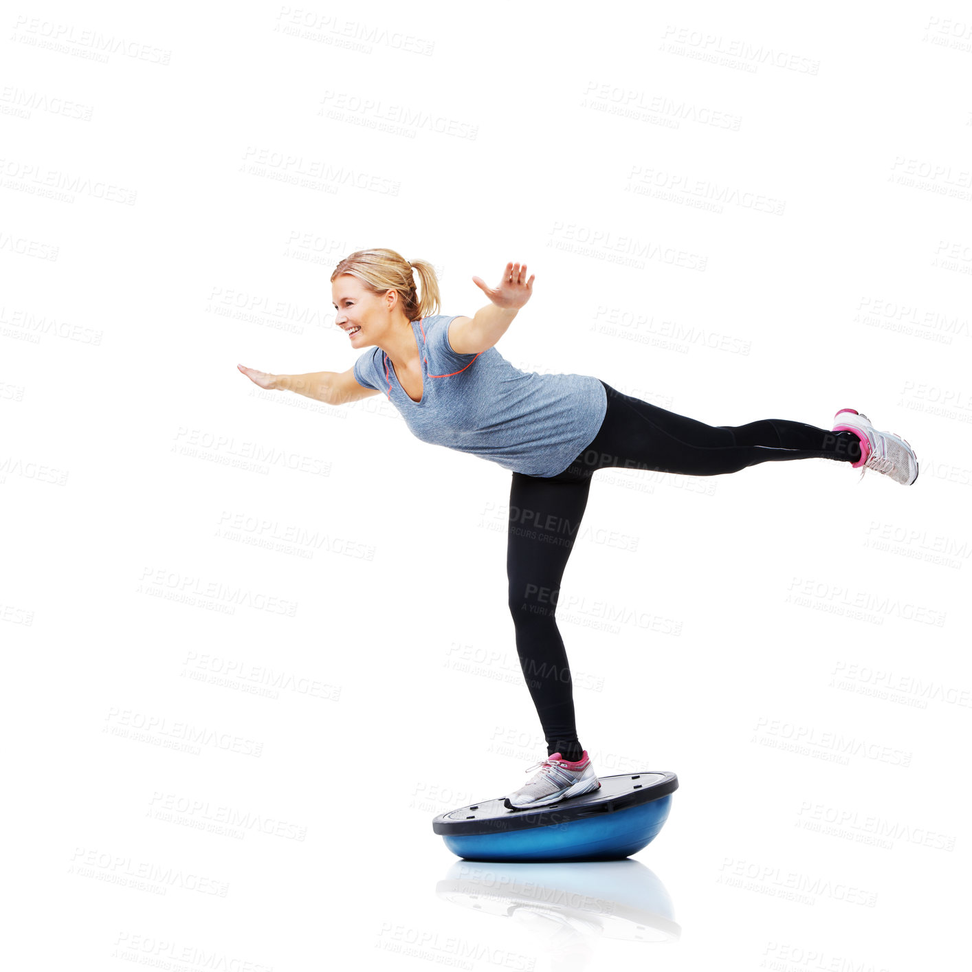 Buy stock photo An attractive young woman working her core muscles by balancing on a bosu-ball