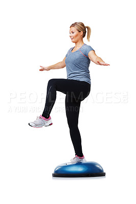 Buy stock photo A young woman standing on a bosu-ball while working out