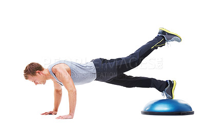 Buy stock photo A young man working his upper body using a bosu-ball