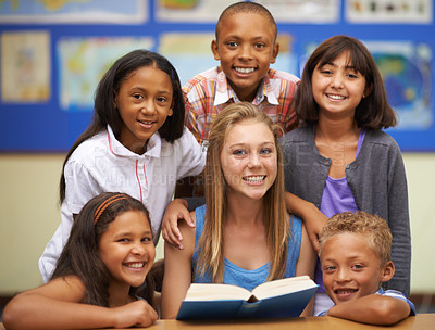 Buy stock photo Children, tutor and portrait with group in classroom for knowledge, learning or education with happiness. Face, student and woman at school with study, textbook and smile with diversity at college