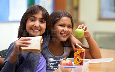 Buy stock photo Girls, happy and portrait with lunch at school for recess, break or nutrition at table with diversity. Kids, face and smile at academy or relax with confidence, food or embrace for friendship or care