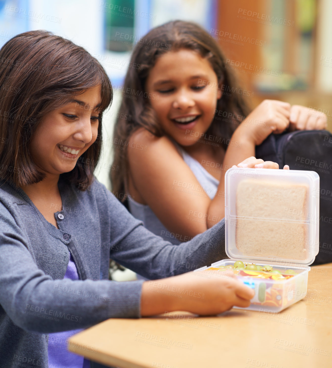 Buy stock photo Happy girl, friends and student with lunchbox for eating meal, break or snack time in classroom at school. Young kids or elementary children smile for container, food or fiber and nutrition in recess