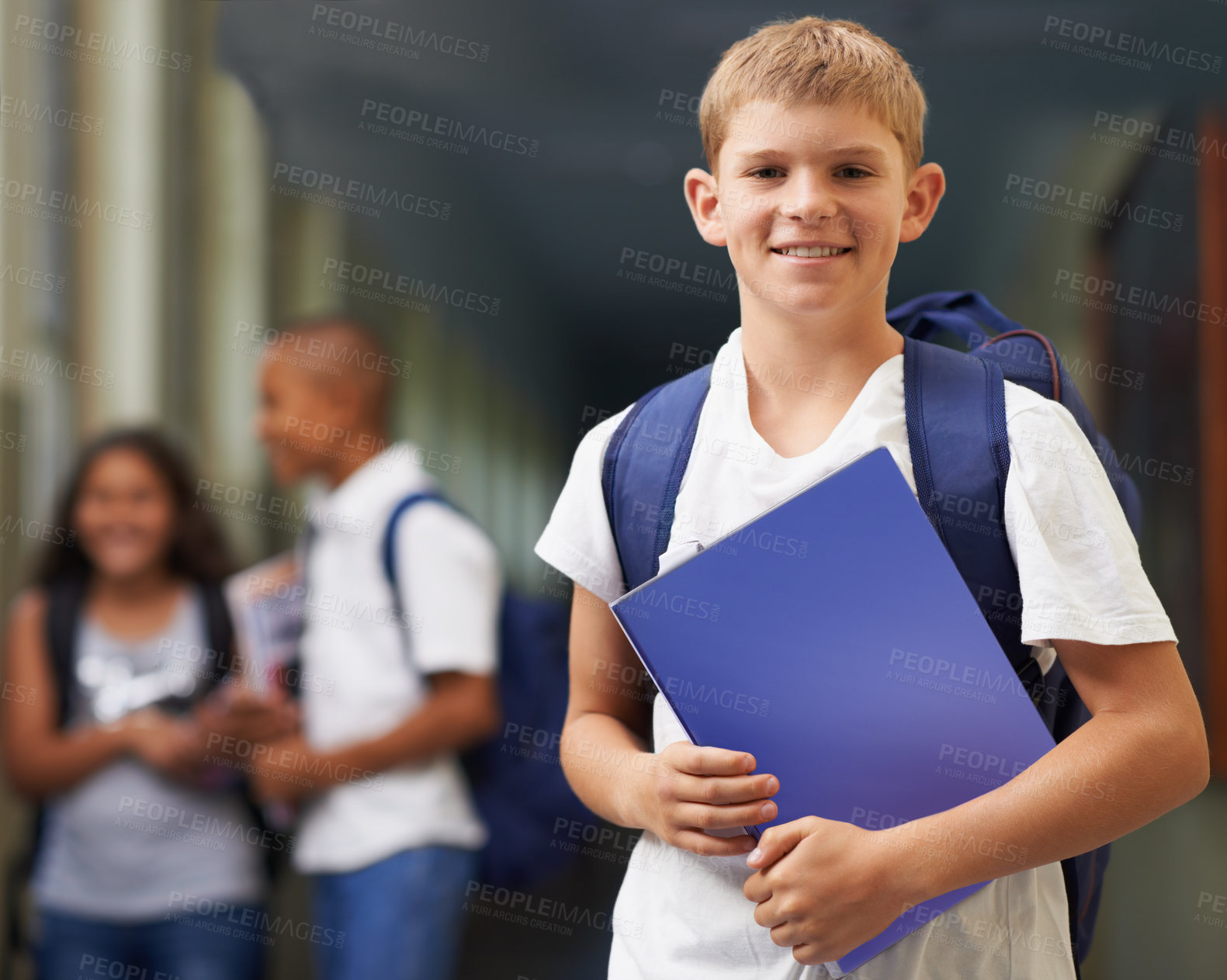 Buy stock photo Boy, portrait and happy in corridor of school with backpack and books for learning, education or knowledge. Student, person and face with smile in building or hallway before class or ready to study  