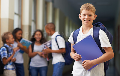 Buy stock photo Boy, portrait and smile in corridor of school with backpack and books for learning, education or knowledge. Student, person and face with happy in building or hallway before class or ready to study  
