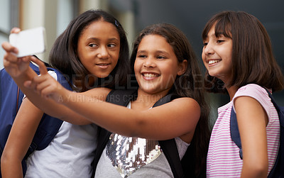Buy stock photo Elementary school friends, girls and selfie with smile for fun educational memory together. Diversity, young students and group of happy kids taking picture for social media, photography and learning