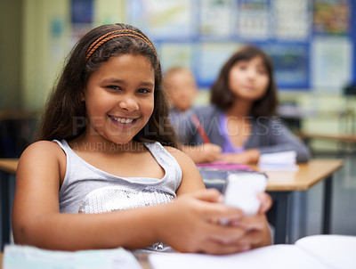 Buy stock photo School, students or portrait of girl with phone for texting, gossip or message notification in classroom. News, sharing or happy child with a meme on mobile app or social media for online distraction