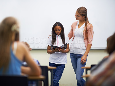 Buy stock photo Presentation, class and teacher with book to read in front for classmates, ready and learning. Elementary school, girl and prepared oral with workbook, childhood development and academic education
