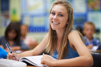 Buy stock photo Girl, classroom and writing in portrait for education, learning and notes for knowledge in high school. Female person, book and pride for assessment or test, studying lesson and happy at academy