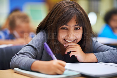 Buy stock photo Girl, education and portrait in classroom for learning, information and notes for knowledge in school. Female person, book and pride for assessment or test, studying lesson and smiling at academy
