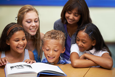 Buy stock photo School teacher, education and reading book with students, classroom and knowledge or learning. Female person, children and literature for english development, collaboration and support at academy