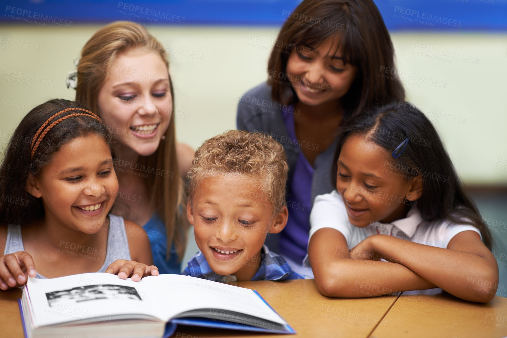 Buy stock photo School teacher, education and reading book with students, classroom and knowledge or learning. Female person, children and literature for english development, collaboration and support at academy