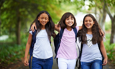 Buy stock photo Happy woman, friends and hug walking with backpack in park for unity, teamwork or school together. Group of young people or teens in nature path with bag for learning, education or outdoor class
