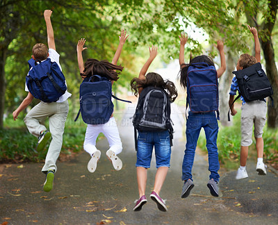 Buy stock photo Rear view of excited schoolchildren jumping in a row