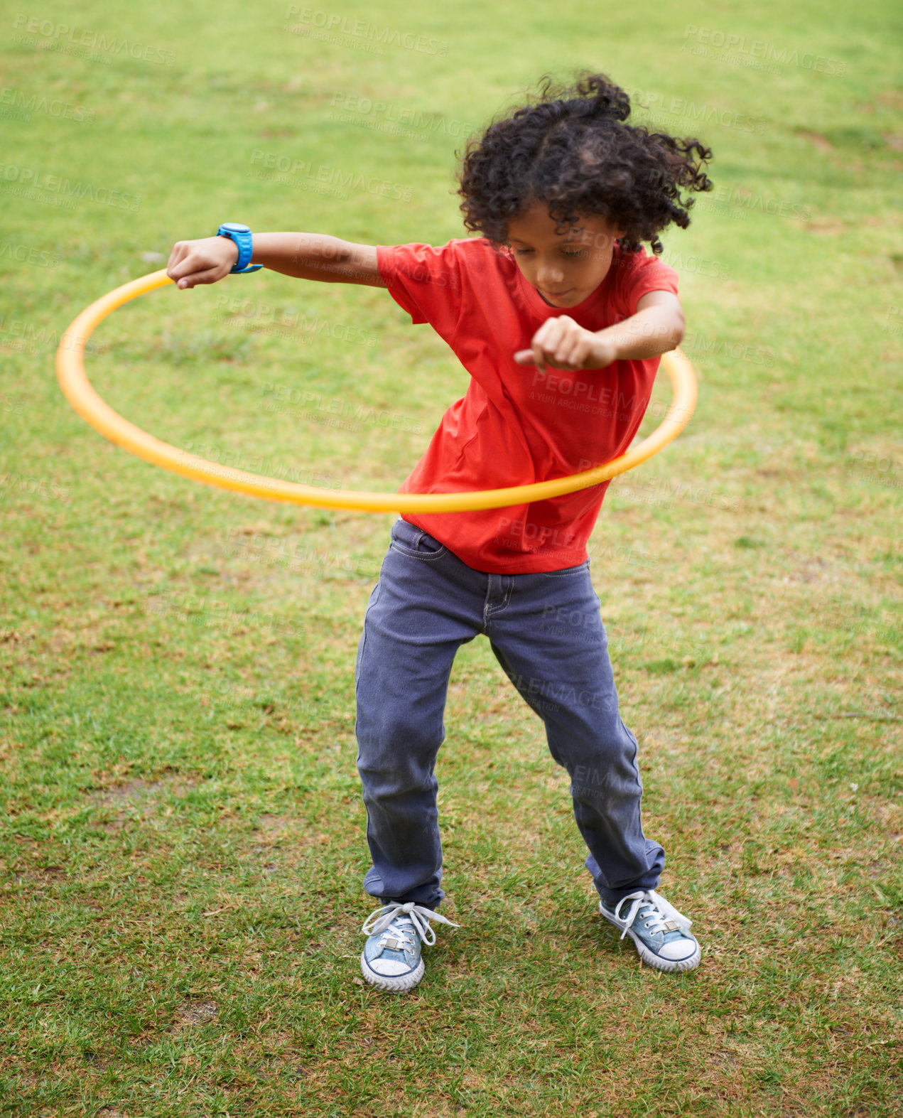 Buy stock photo Child, playing and hula hoop on field on vacation, green grass and sunshine with happiness in city. Young boy, mexican and game on playground, summer holiday and leisure with wellness in urban town