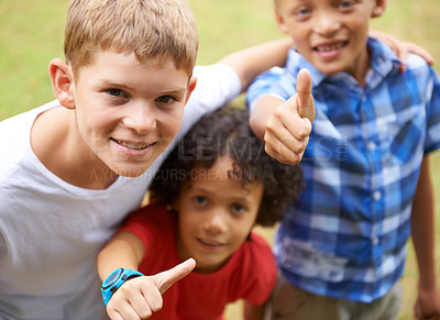 Buy stock photo Happy children, portrait and thumbs up in nature for teamwork, winning or good job together at park. Group of casual young boys smile and hug with like emoji, yes sign or OK for outdoor success